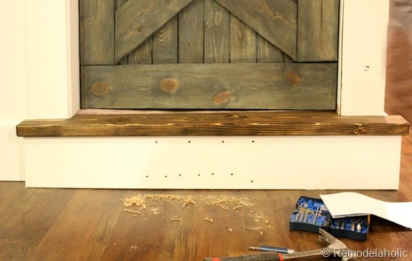 building out stair with wood bullnose and house numbers under barn door (13)