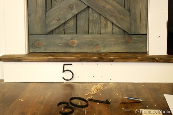building out stair with wood bullnose and house numbers under barn door (14)