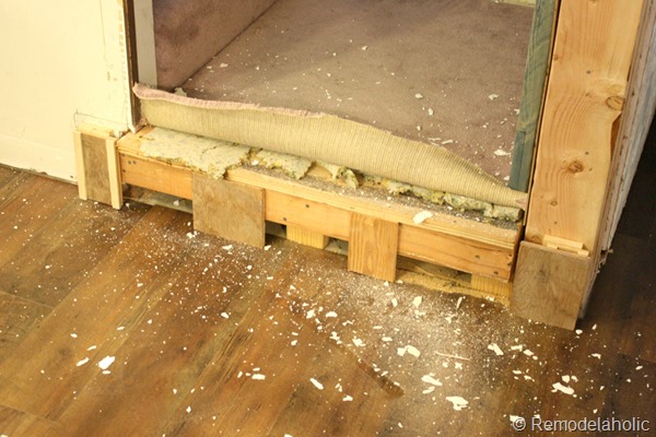 building out stair with wood bullnose and house numbers under barn door (1)