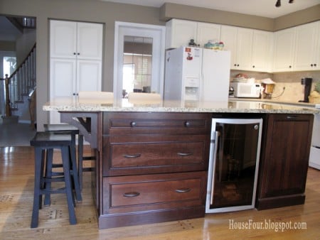 new kitchen island with built-in fridge and bookshelf, House for Four via Remodelaholic.com