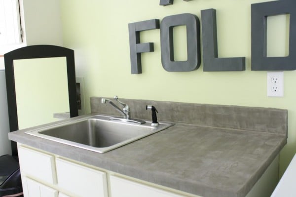 laundry room cement countertops, featured on Remodelaholic