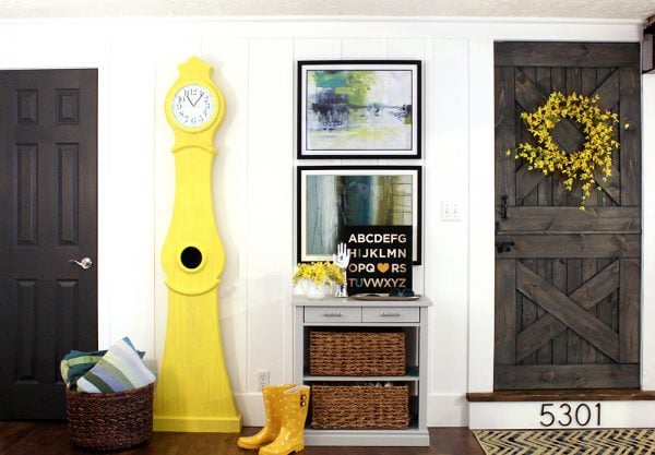 board and batten wall wity yellow Swedish Clock 