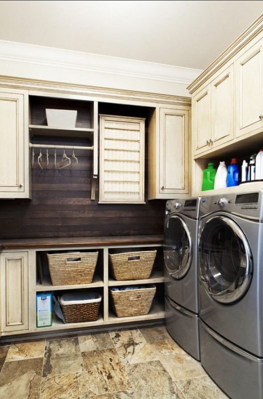 laundry with lots of storage space and hanging rack featured on remodelaholic.com