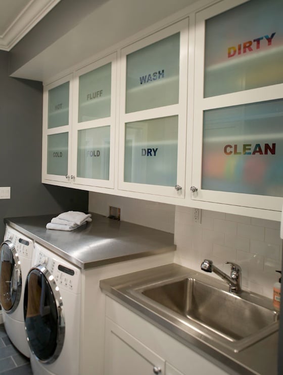 modern cabinet frosted glass storage area above washer and dryer in the laundry room featured on Remodelaholic.com