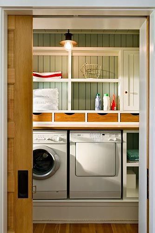 Beach vibe laundry room full over extra storage and charm featured on Remodelaholic.com