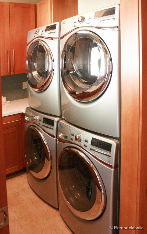Double stacked machines for effective use of space in the laundry room. Fabulous Laundry room design ideas from @Remodelaholic