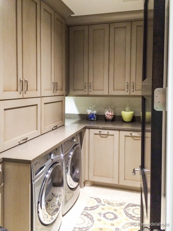 Tall cabinets add extra storage to this laundry room. Fabulous Laundry room design ideas from @Remodelaholic