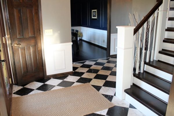 tile checker entryway with wood and white curved staircase - Construction2Style via @Remodelaholic